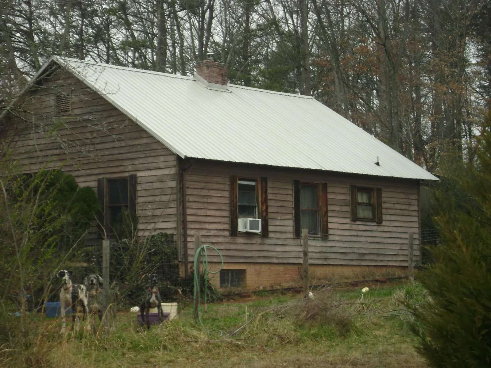 White metal roof on an old wood sided farmhouse, from a Metal Roof Installation job in Chester